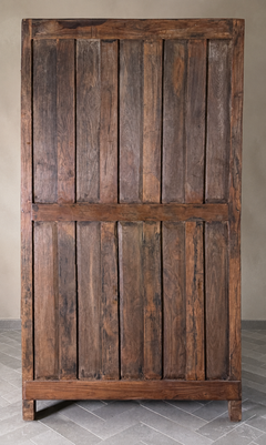 Wooden panel with vertical slats on a neutral background