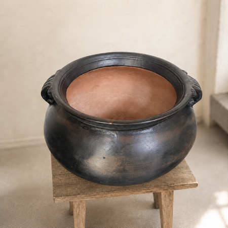 Large-earthenware-pot-on-wooden-stool