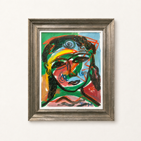 Framed abstract painting with a colorful face on a white wall