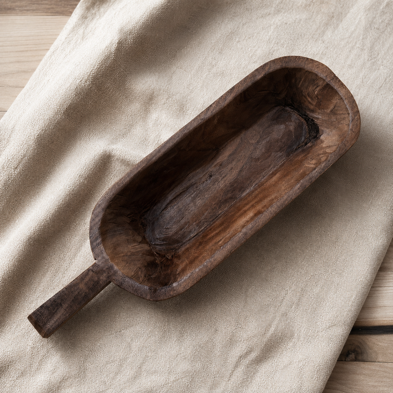 Wooden scoop on a beige fabric background