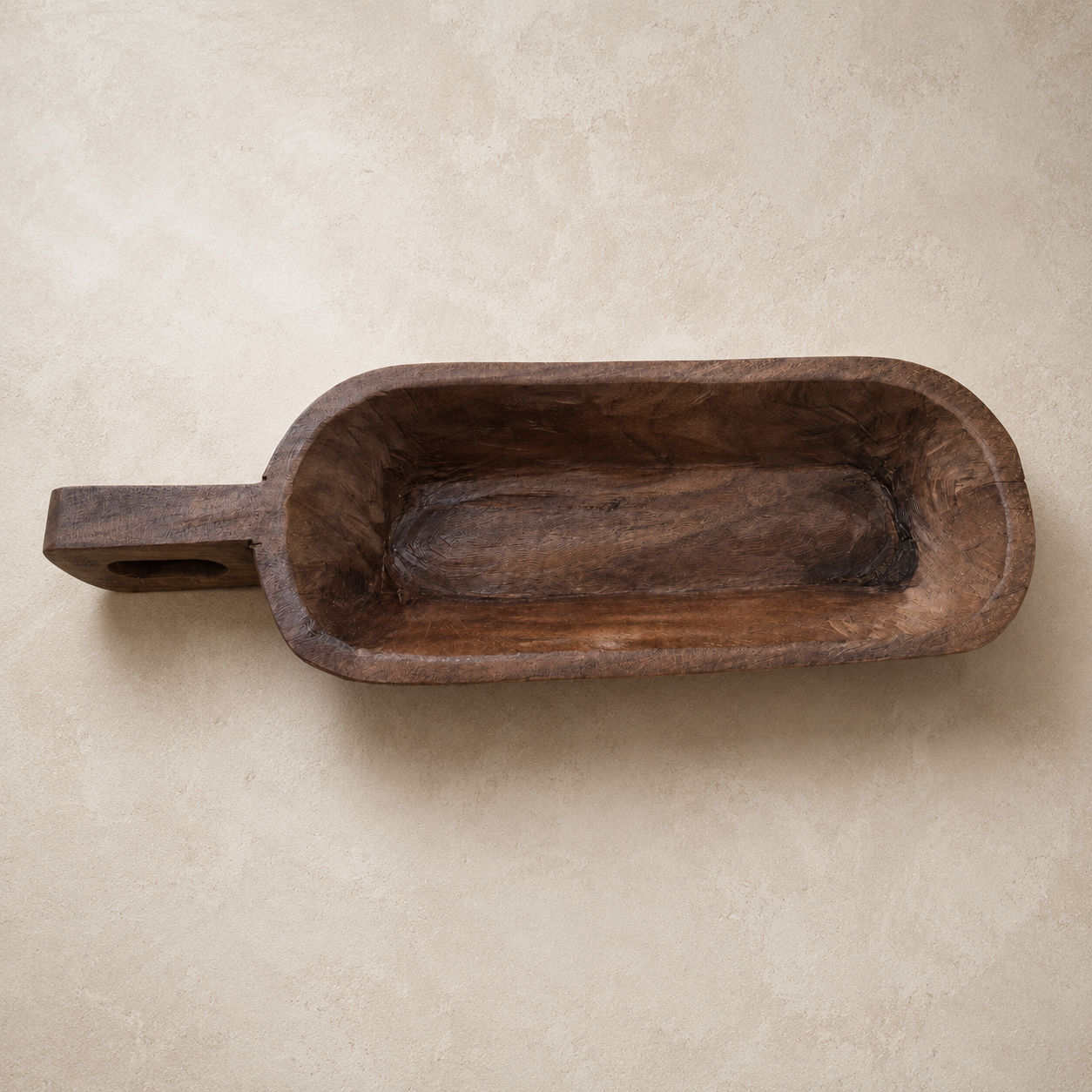 Wooden scoop on a beige background