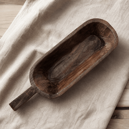 Wooden scoop on a beige fabric surface