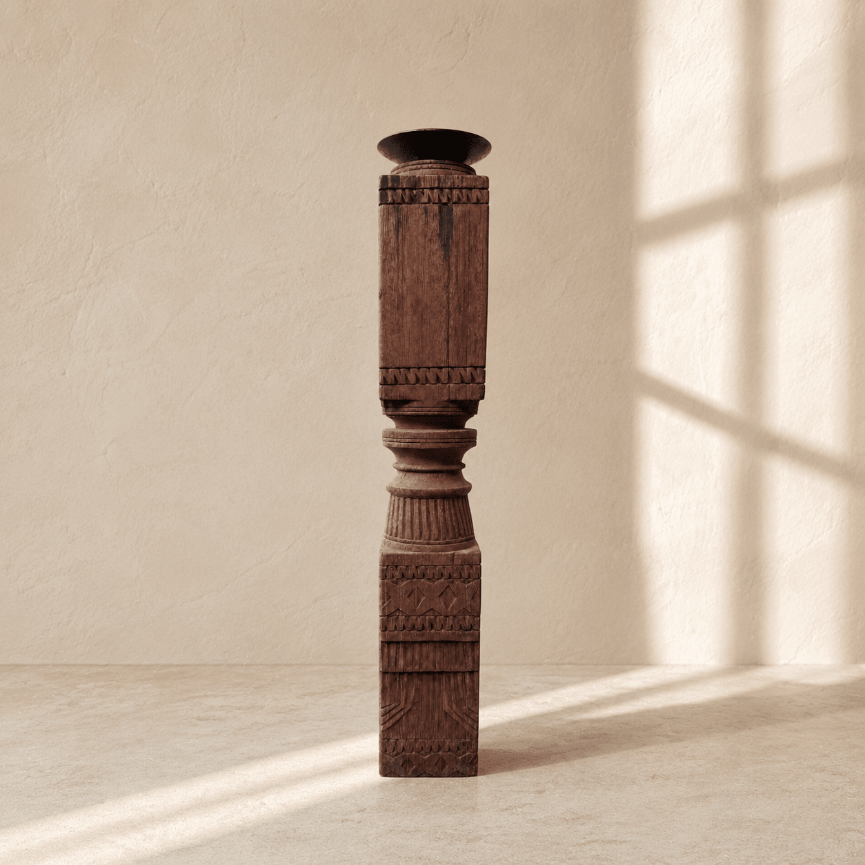 Decorative wooden column against a beige wall with sunlight casting shadows.