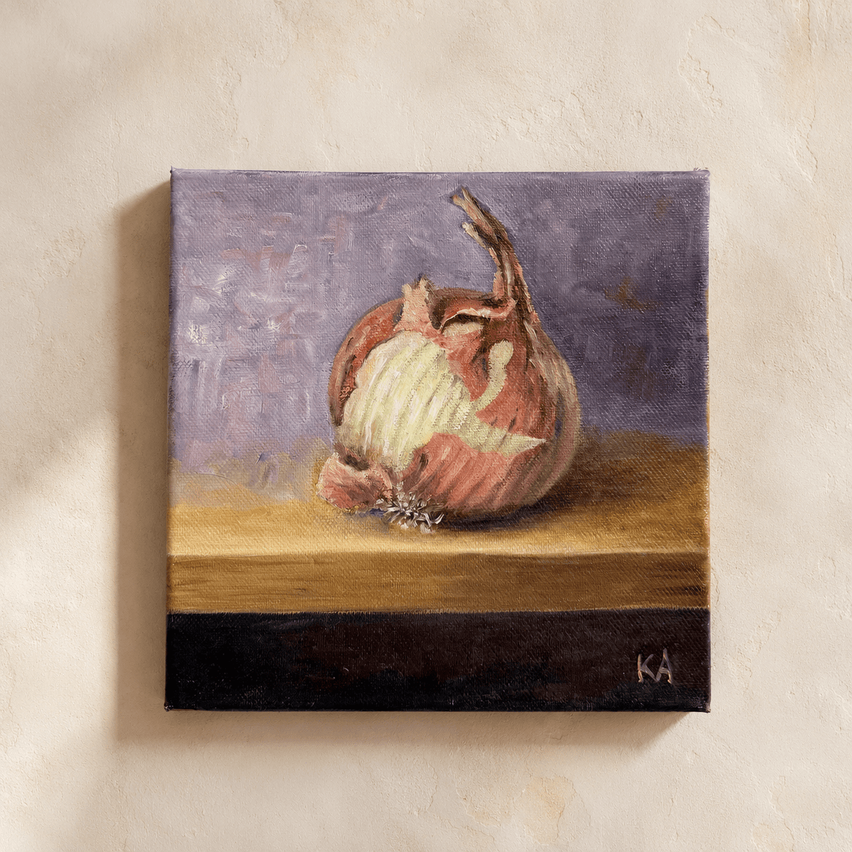 A square canvas painting of an onion on a tabletop against a purple background, mounted on a textured beige wall.