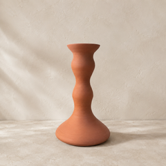 Terracotta candle holder on a neutral background