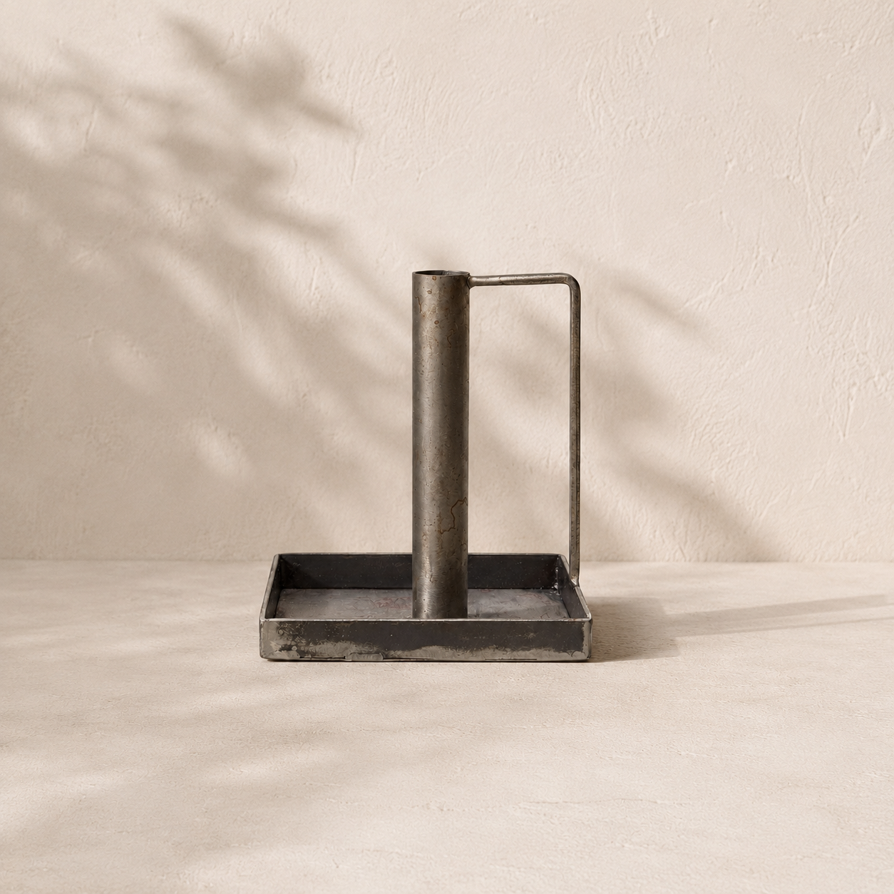 Decorative metal candlestick on a beige background