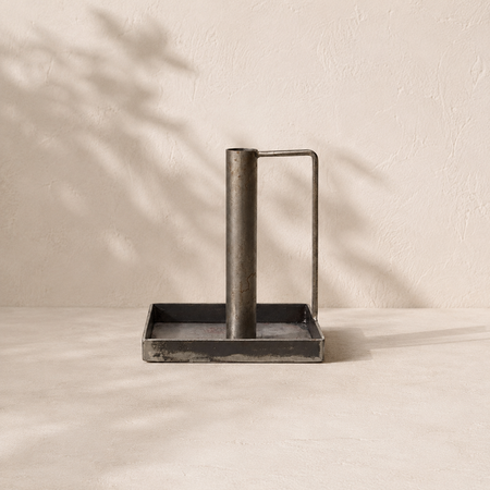 Decorative metal candlestick on a beige background