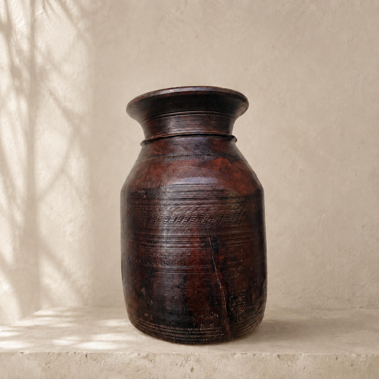 Brown wooden vase on a beige surface with a neutral background