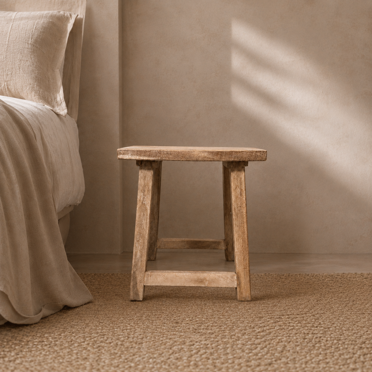 Wooden stool against a beige wall in a bedroom setting
