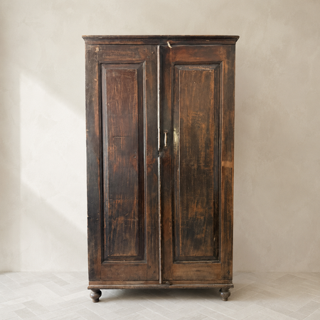 Vintage wooden wardrobe against a neutral background